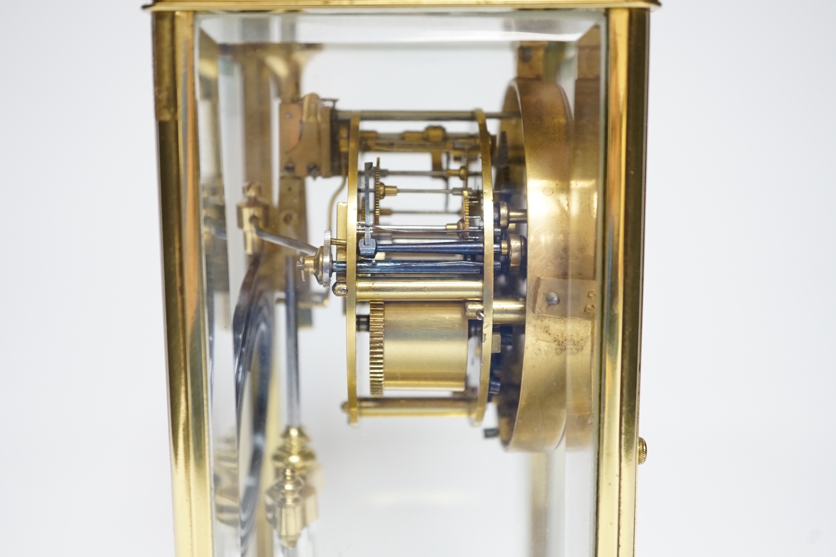An early 20th century brass four glass clock retailed by Dent, 22cm